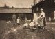 Karin matar gässen medan Ernst och Carl-Anders ser på, foto från besök i Lindor 1924